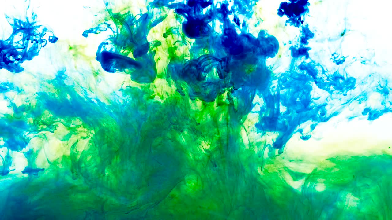 4K footage of green and blue colorful ink drops in water, isolated abstract background. Pouring ink in water. Underwater paint mix. Slow psychedelic dye swirls, colored smoke explosion. Splashing, floating liquid