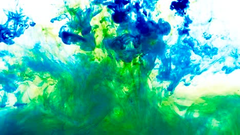 4k footage of green and blue colorful ink drops in water, isolated abstract background. pouring ink in water. underwater paint mix. slow psychedelic dye swirls, colored smoke explosion. splashing, floating liquid