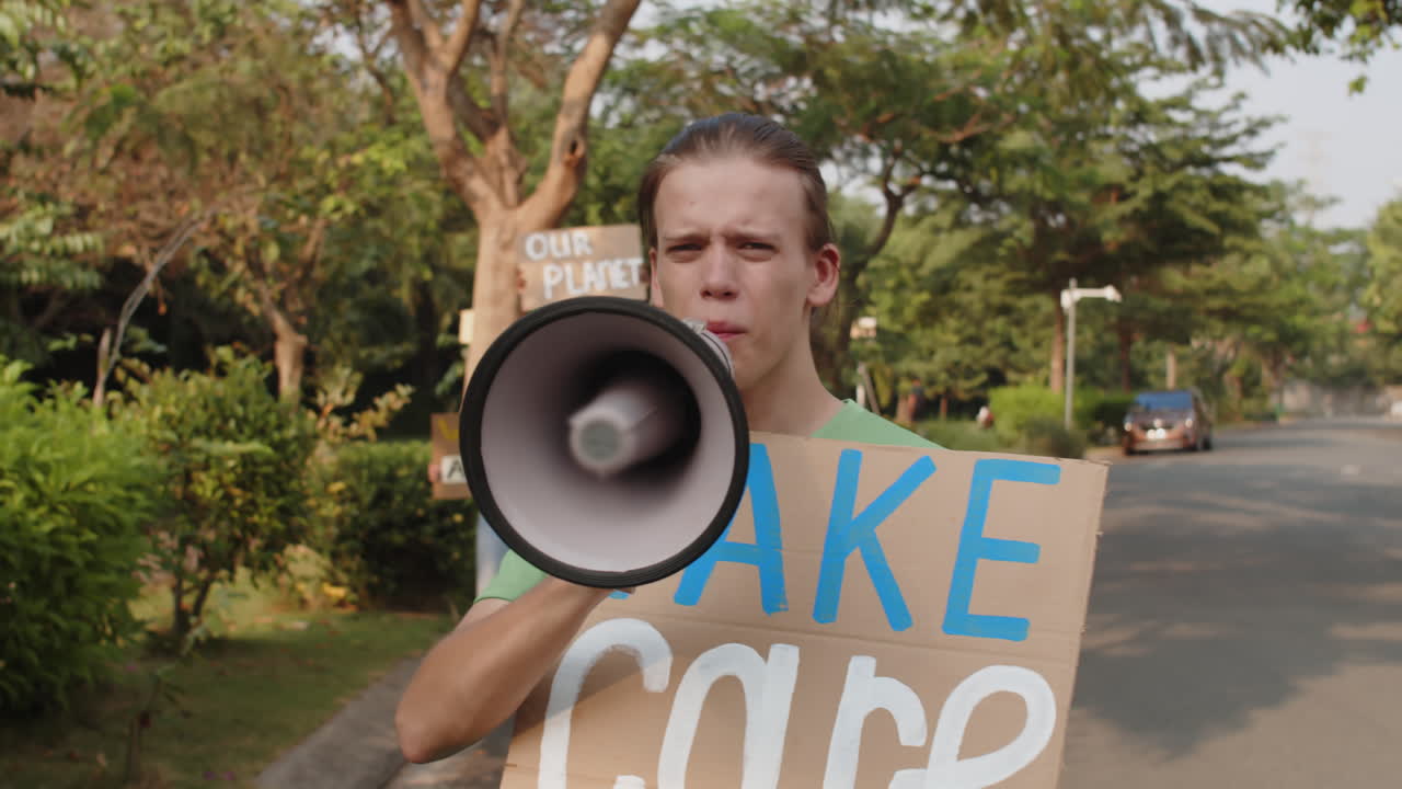 Young Man Shouting in Horn when Protesting with Eco Activists