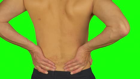 man rubbing by palm his lower back due pain in back. adult caucasian man back view.