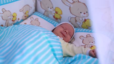 little baby in white bodysuit peacefully sleeping on parents hand little baby in white bodysuit peacefully sleeping on parents hand fathers finger is touching tiny kids nose close up