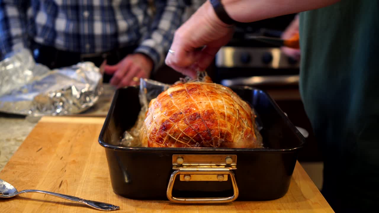 Removing the trussing from a roast turkey
