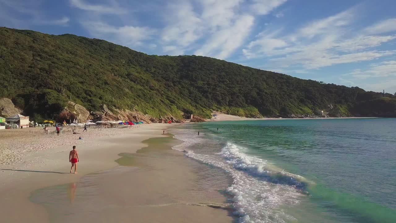 Beautiful beach with people enjoying leisure time on the Arraial do Cabo region in Brazil