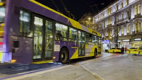 Busy-street-in-Athens,-Greecer-at-night-with-traffic---Panepistimiou