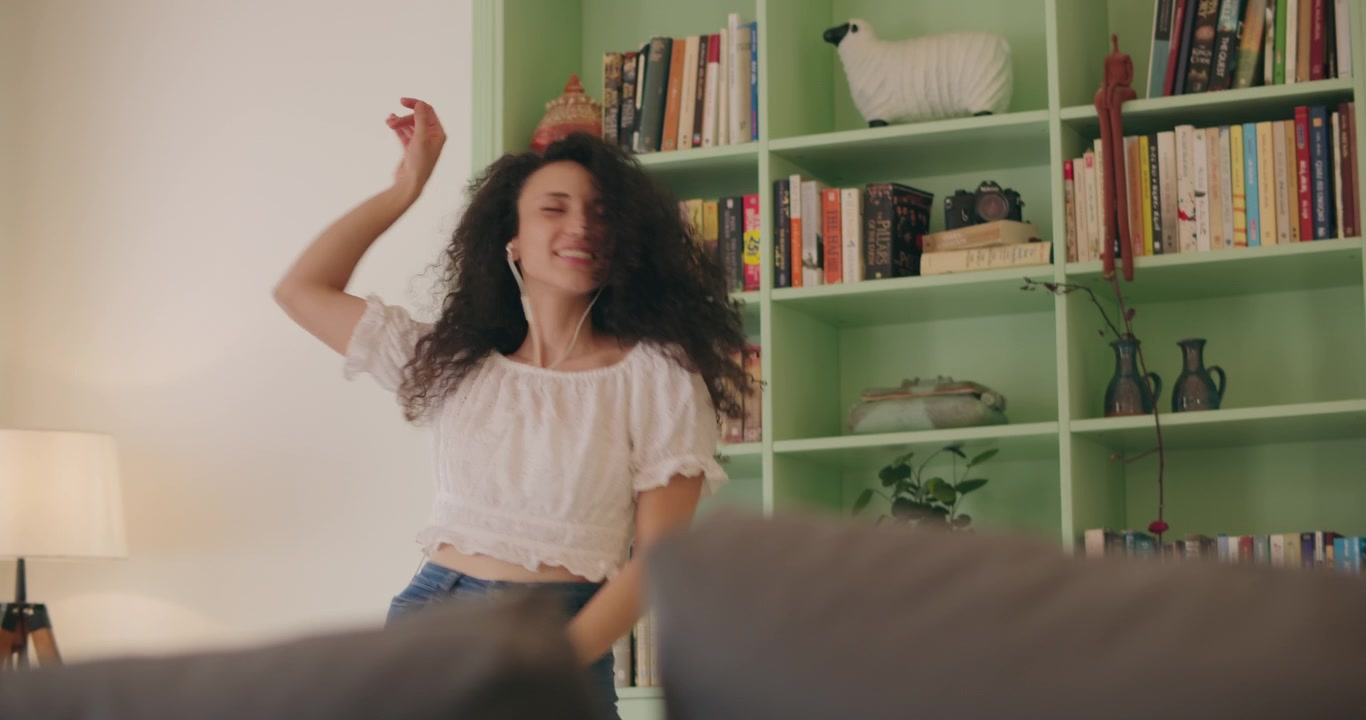 Carefree woman enjoys dancing alone