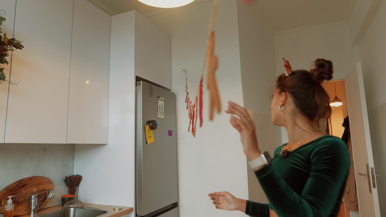 Woman decorating kitchen for Christmas