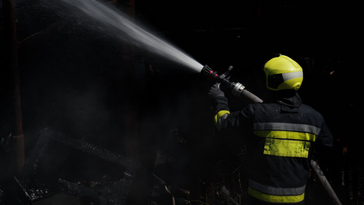 Firefighter trying to extinguish a house on fire