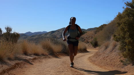 Woman Trail Running in the Mountains