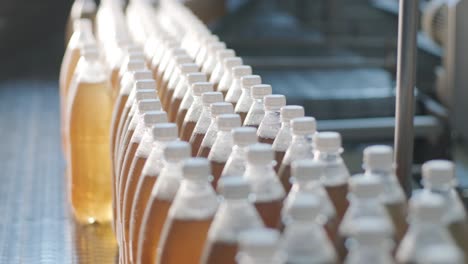 conveyor belt with bottles for juice or water at a modern beverage plant. modern production of sweet soda water