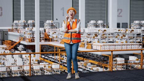 full body of asian female engineer with safety helmet standing in the warehouse with shelves full of delivery goods. thinking about something and looking around then raising her index finger