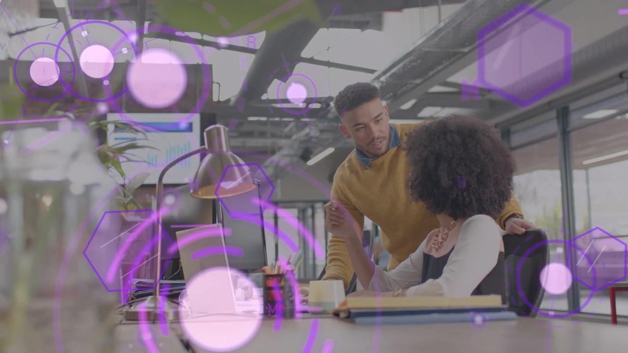 Man leaning and pointing at laptop urging woman checking business report as purple graphics overlay