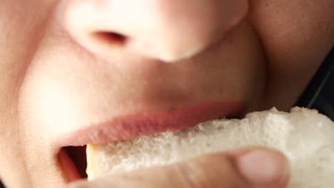 close-up of a person eating a piece of bread