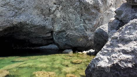 a natural rock pool filled with clear water in sudak, crimea, russia