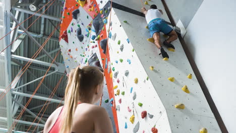 personas en un centro de pared de escalada