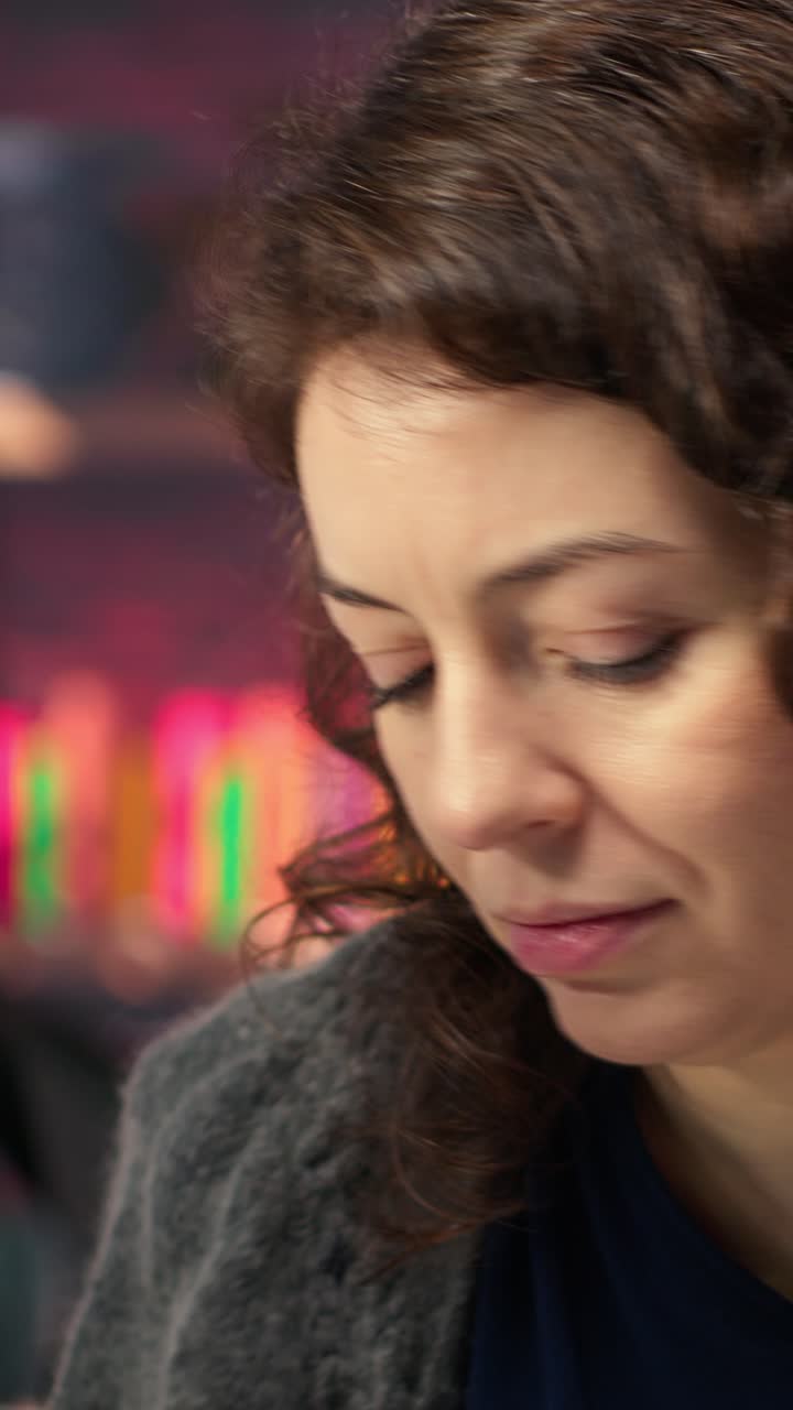 Vertical Video IT specialist at workstation programming on monitor and writing lines of code