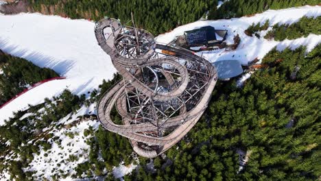 Flying-above-sky-walk-tower-attraction,-Dolni-Morava-snowy-mountain-slope