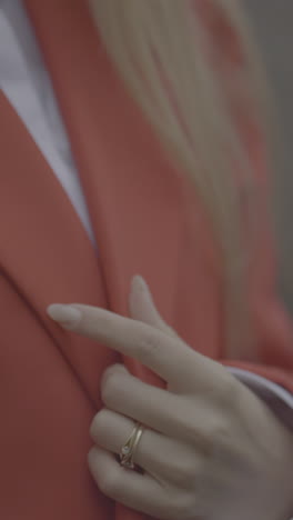 woman's hand with ring and jacket