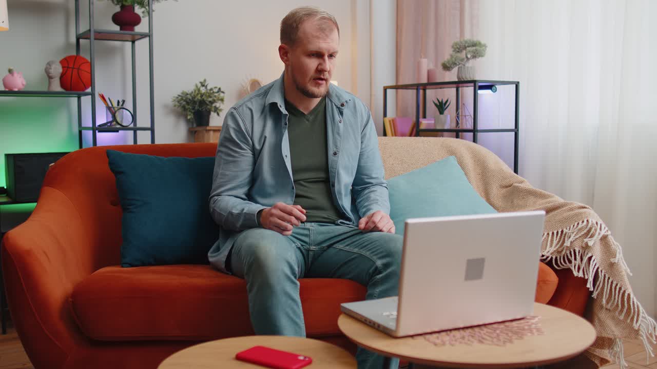 Busy man worker manager consulting client online by laptop using webcam of notebook at home office
