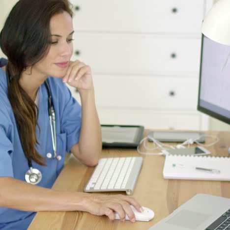 Doctor-working-at-her-desk-in-the-office