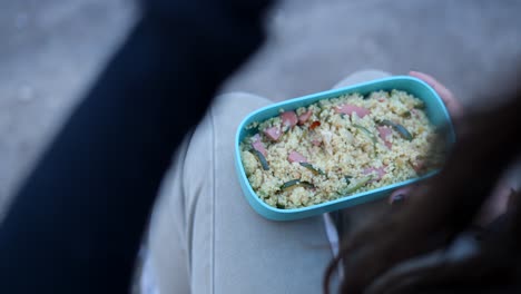 woman eating lunch from a lunchbox