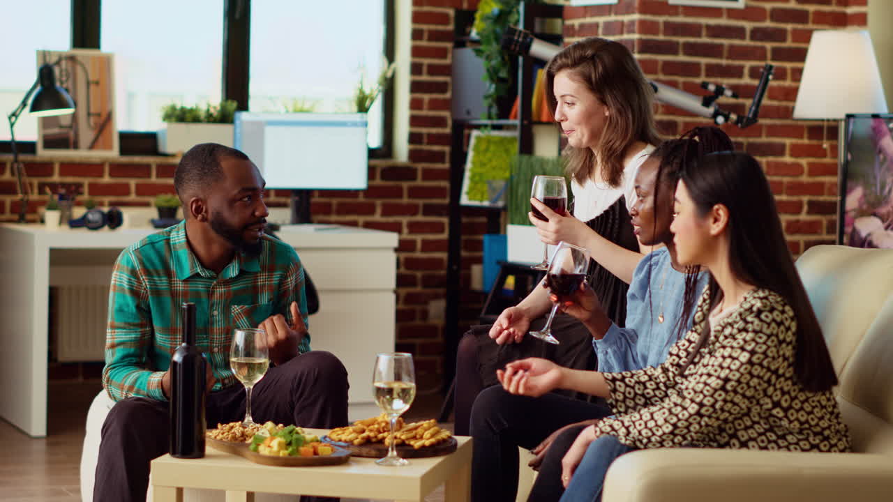 Merry guests laughing in modern living room after gifting host presents