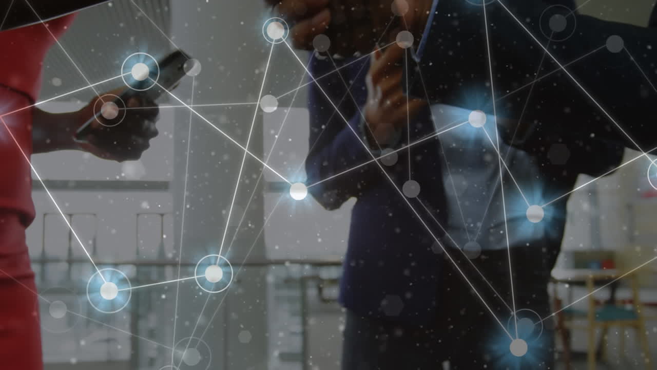 Animation of network of connections over mid section of businessman and businesswoman shaking hands