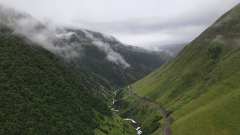 aerial shot of caucasian mountains fog valley river