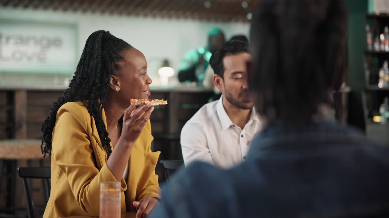 Friends Enjoying Pizza at a Restaurant