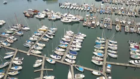 4k drone flying over boat club showing boats and sailboats in vancouver, canada