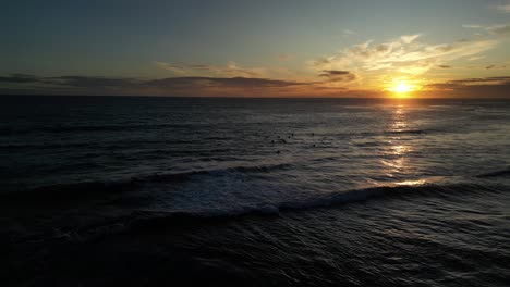 Aerial-wide-shot-showing-group-of-surfer-in-the-ocean-during-golden-hour---Waiting-for-perfect-waves-in-Australia