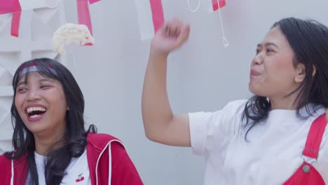excited young teenage girl winning the eating crackers competition on indonesia independence day celebration