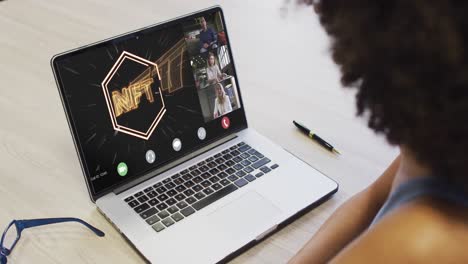 Video-of-african-american-woman-having-nft-video-call-on-laptop-with-diverse-coworkers