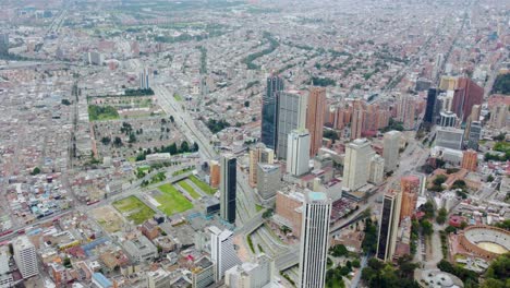 Droneshot-tilting-up-above-Bogota-city,-showing-skyscrapers