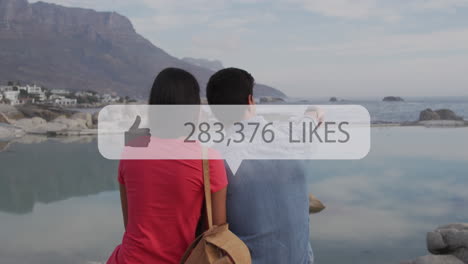 animation of notification bars over rear view of diverse couple sitting and enjoying scenic view