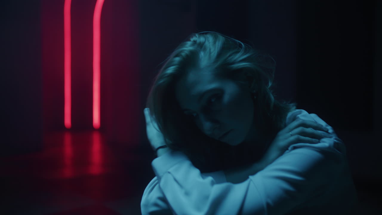 Woman sitting in neon light