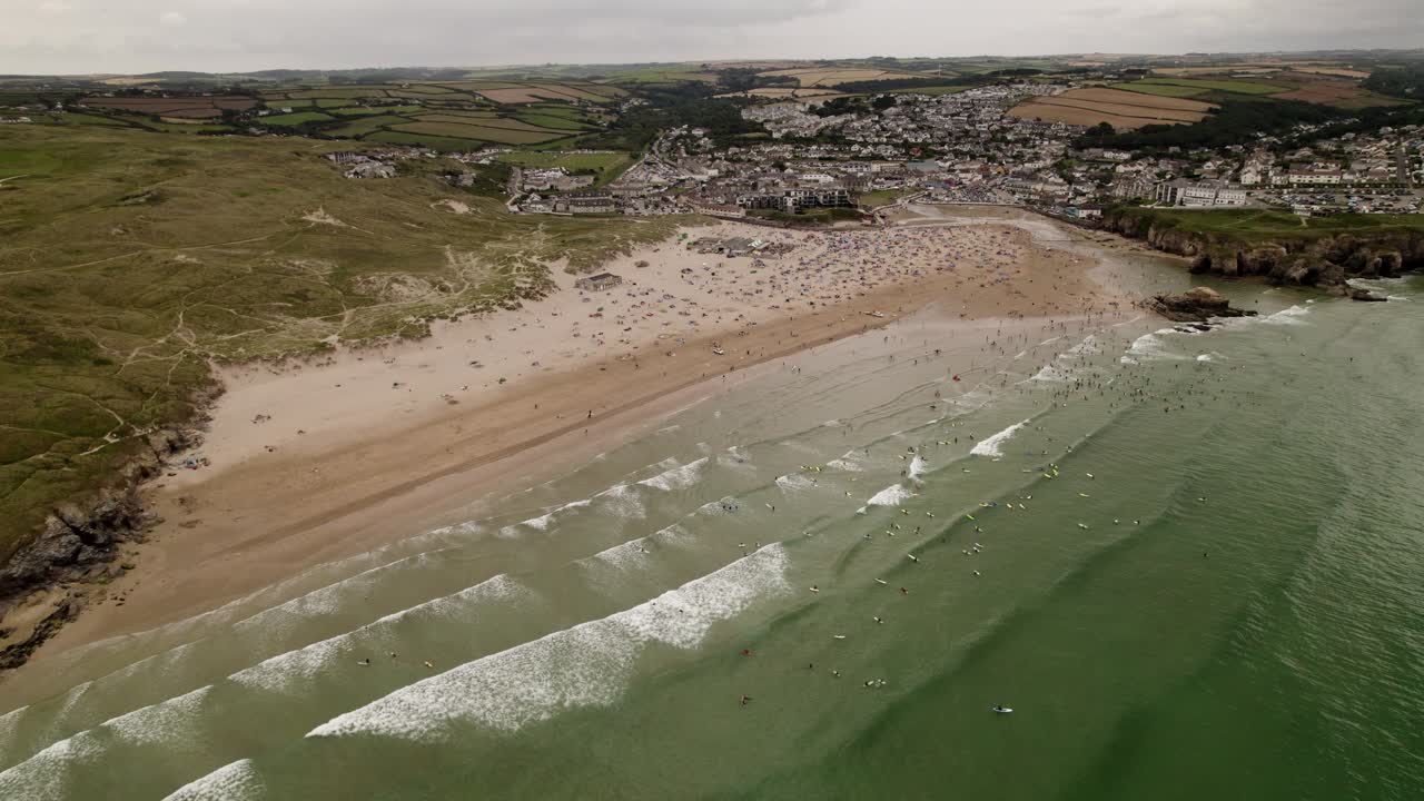 Perranporth Beach And Sea Full Of Summer Surfers and Swimmers Aerial View