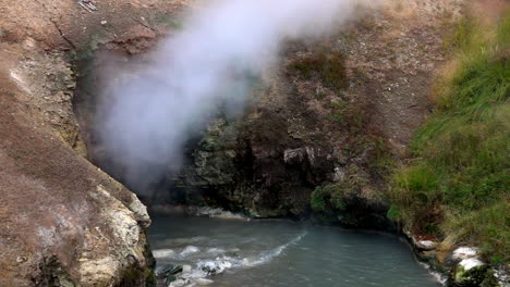 slow motion shot of steam venting from dragon's mouth spring in yellowstone national park