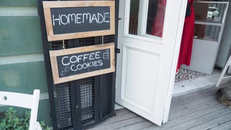 a charming coffee shop with a chalkboard sign that says 'homemade coffee cookies'