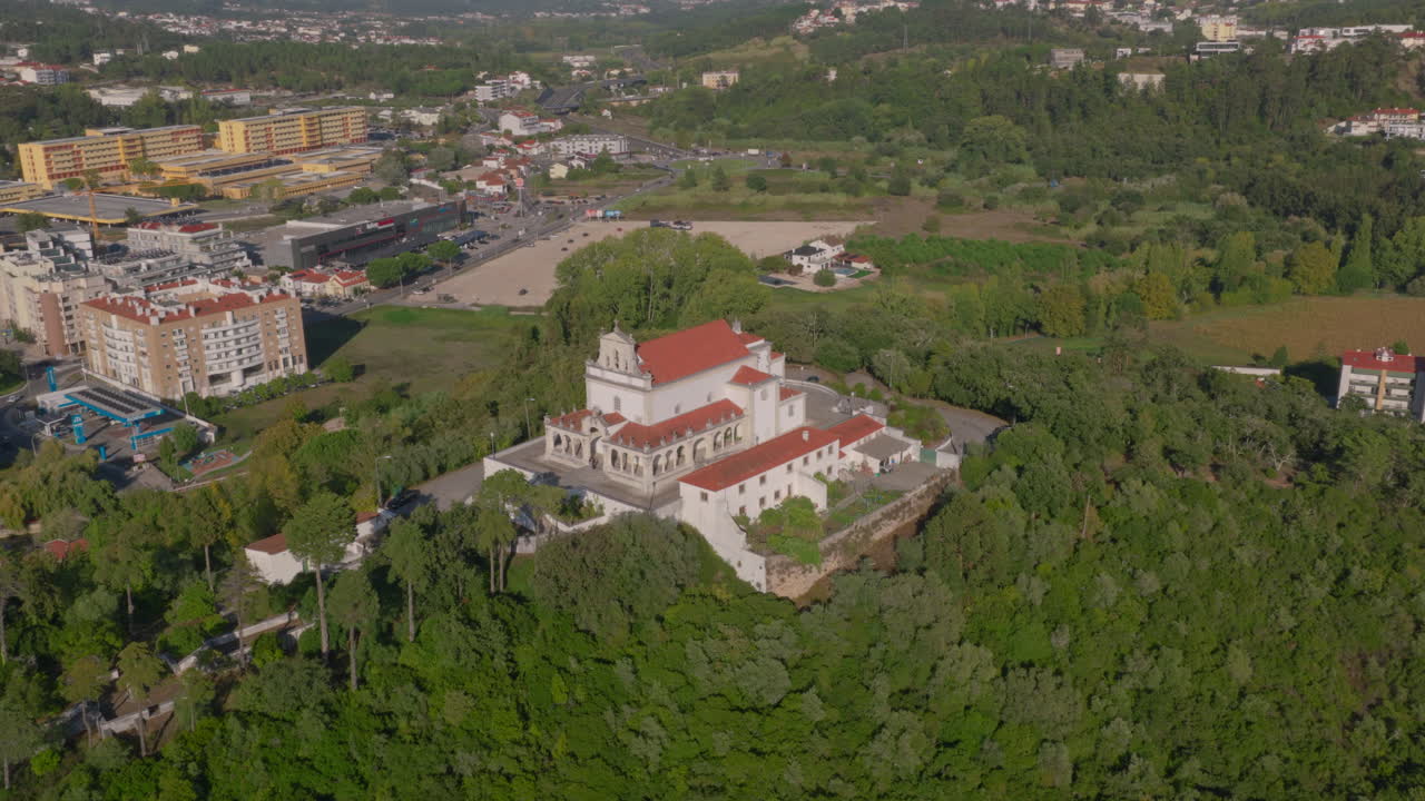 Our Lady of the Incarnation sanctuary aerial slow orbit clockwise, wide establishing view over hilltop and city below