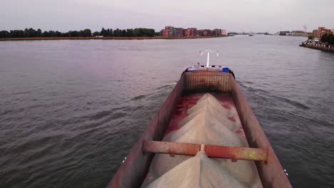 Cargo-ship-carrying-sand-through-dutch-canal