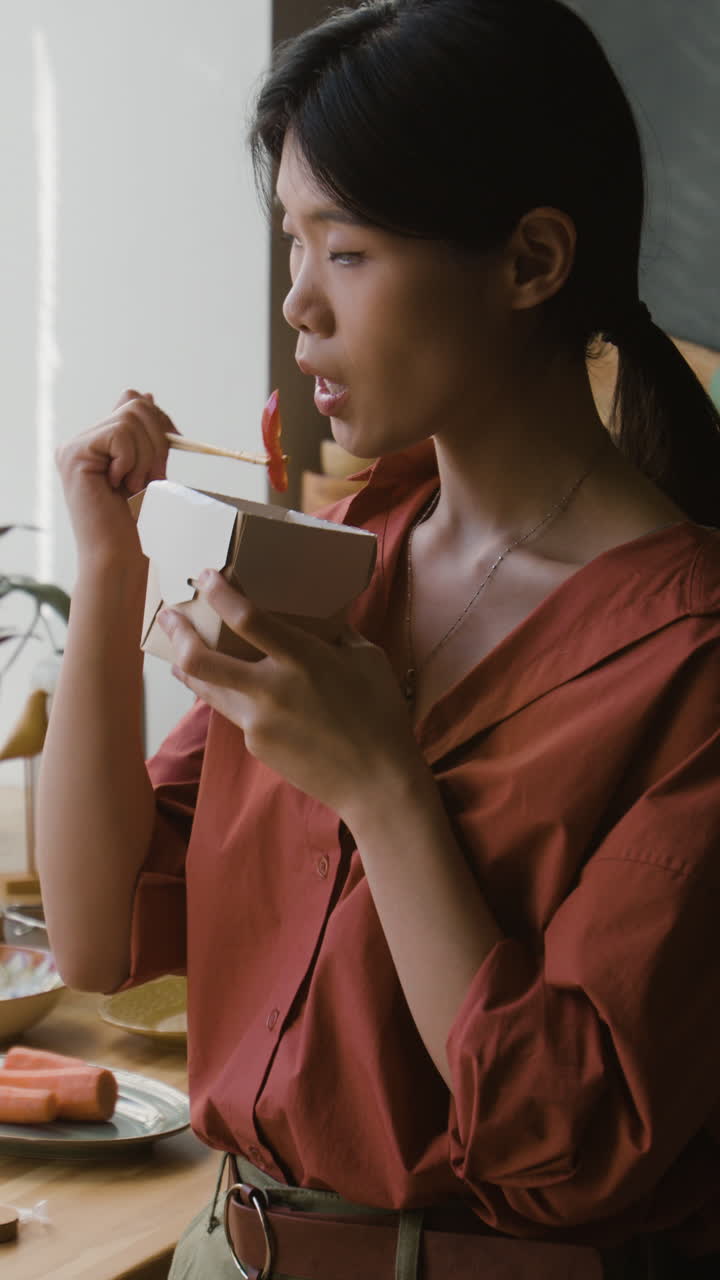 Young Woman Enjoying a Delicious Takeout Meal