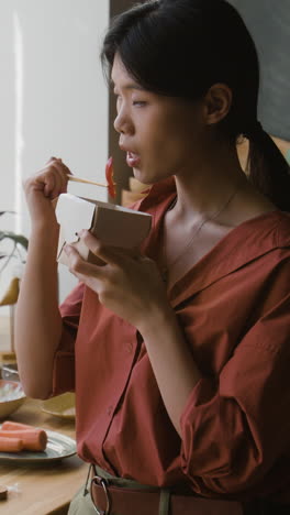 young woman enjoying a delicious takeout meal