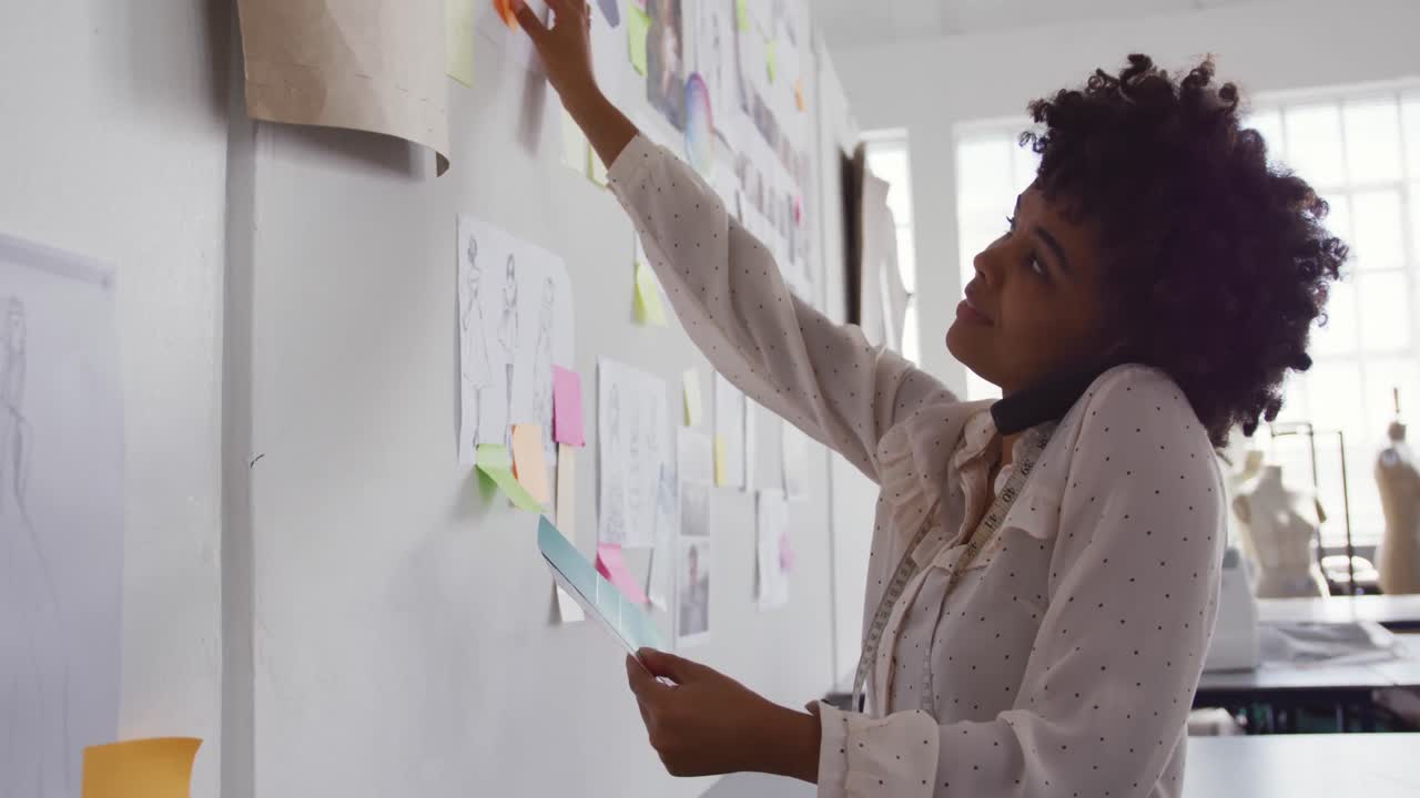 Mixed race woman working in fashion office