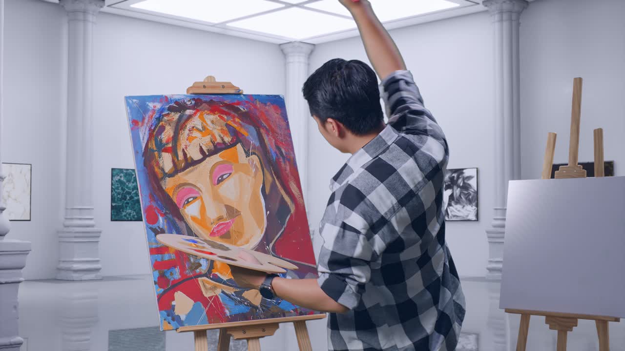 아시아 남성 예술가의 측면 뷰는 갤러리에서 오일 페인트와 으로 캔버스에 소녀를 그리는 것을 즐긴다.