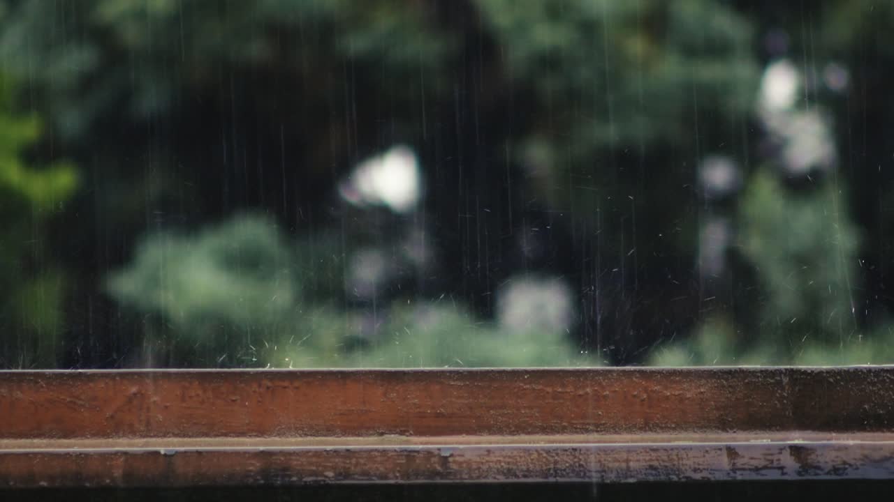 Dancing rain droplets splashing on wooden top SIDE VIEW slow motion
