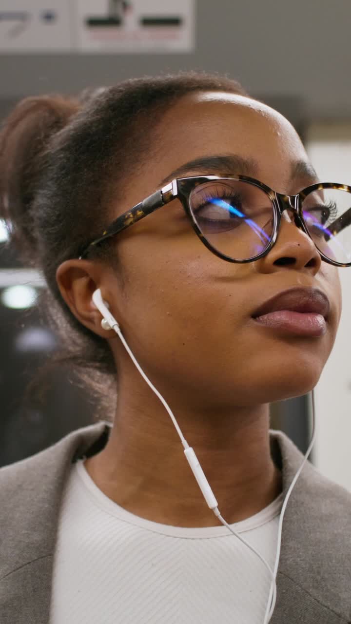 Woman on Subway Wearing Glasses and Headphones