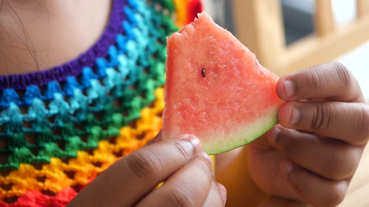 A person eating watermelon