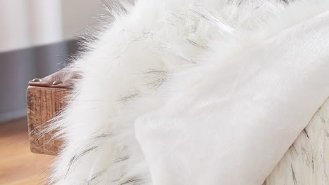fur throw on leather bench as camera pans slowly in soft light