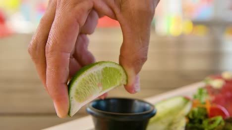 lime squeezed juice dripping on salmon appetizer plate