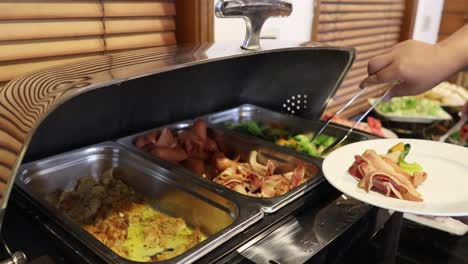 guests filling plates at a breakfast buffet